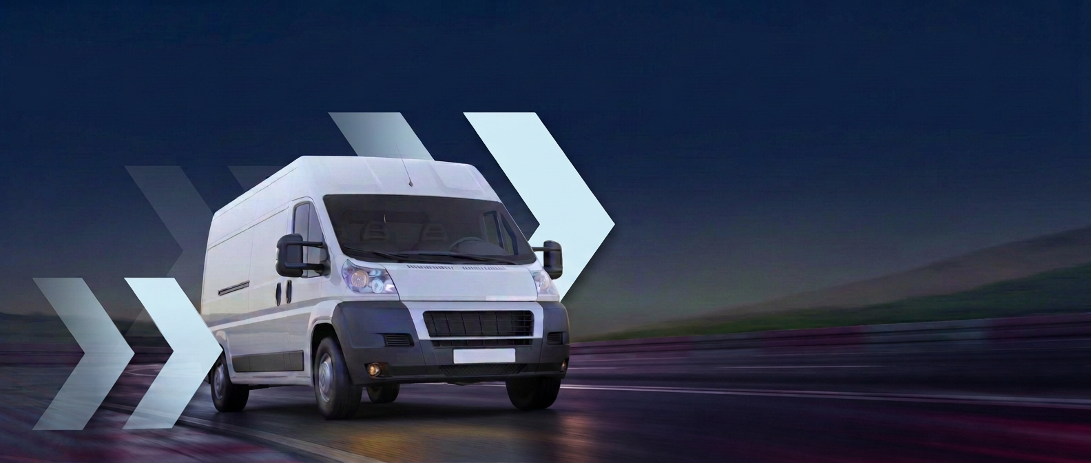 White medical transport van driving on a Florida road at dusk